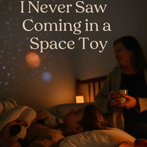 A child lies in bed gazing at a space-themed ceiling projection while holding a plush toy. A parent sits nearby with a warm mug, smiling gently. The room is softly lit with warm tones, and the projected stars and planets create a calming bedtime atmosphere. Overlaid text reads: “The Sleep Hack I Never Saw Coming in a Space Toy.” The scene evokes emotional safety, sensory-friendly sleep support, and a cozy nighttime ritual.