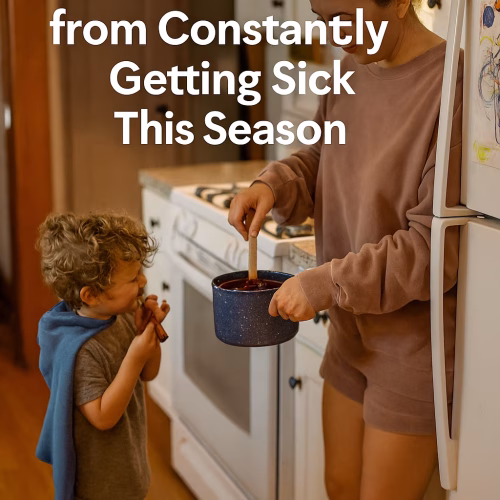 A cozy kitchen scene shows a light-skinned mom stirring elderberry syrup on the stove while her barefoot child in a dish towel cape sniffs cinnamon sticks. The counter holds a “Not Today, Germs” mug, sensory toys, and vitamins. Overlay text reads: “How to Keep Your Feral Child from Constantly Getting Sick This Season.”